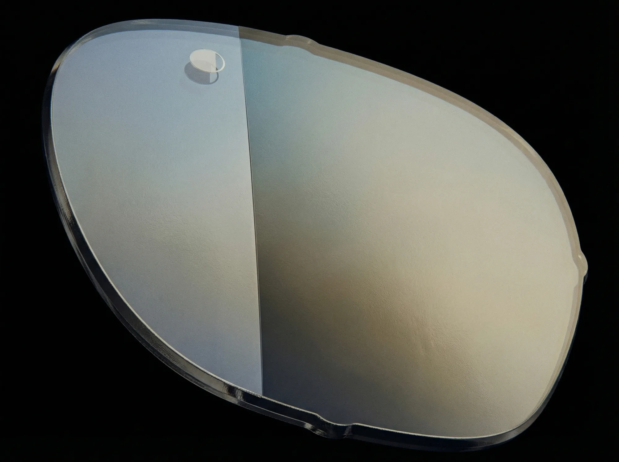 A single HINDSIGHT lens on black — the rear-view mirror, built into a lens.