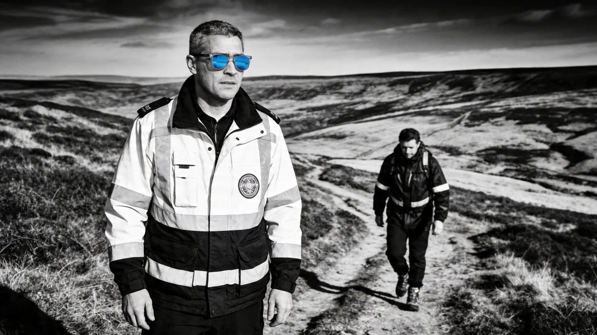 A search and rescue team member wearing HINDSIGHT rear-view mirror eyewear with the rescue partner held in the lens behind.