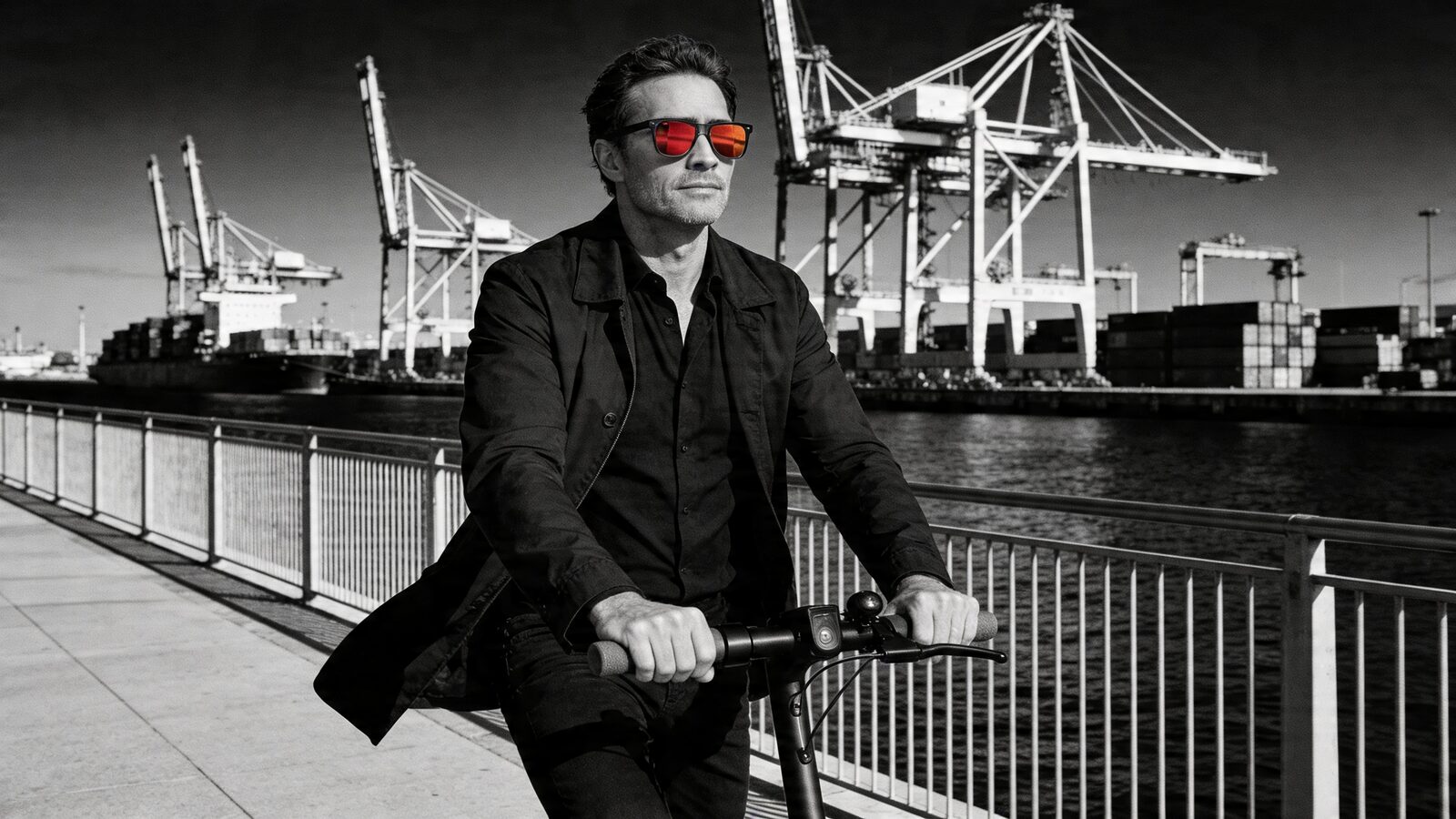E-scooter rider crossing an industrial port, traffic behind held within the HINDSIGHT lens.